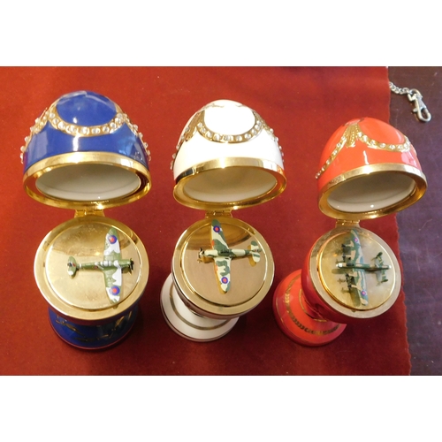 612 - China Faberge Style Eggs on stands. Top lifts to reveal small aircraft, 3 in total, 1 red, 1 white, ... 