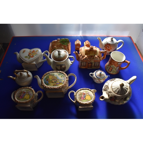 67 - Tea Pots Pottery / Ceramic. Collection of assorted novelty and souvenir tea pots, with jug, saucer a... 