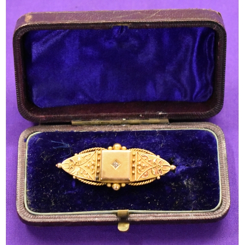 130 - Gold Brooch, stamped 15ct with white cut stone (diamond). Fine gold details, missing pin on back. In... 