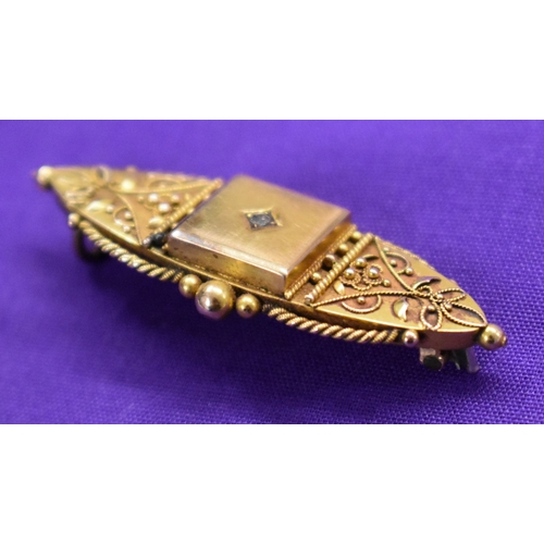 130 - Gold Brooch, stamped 15ct with white cut stone (diamond). Fine gold details, missing pin on back. In... 