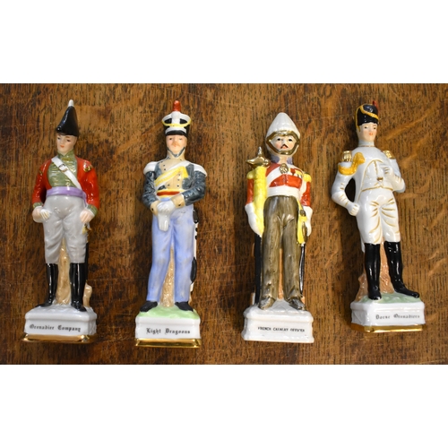 185 - Soldier Statuettes. Collection of bisque / ceramic soldiers (x8). Four soldiers approx 8 inches high... 