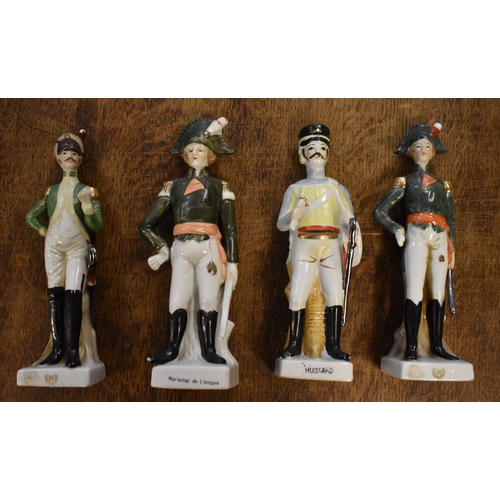 185 - Soldier Statuettes. Collection of bisque / ceramic soldiers (x8). Four soldiers approx 8 inches high... 