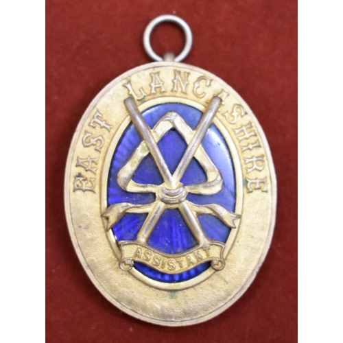 218 - Masonic Pendant. Gilt metal with blue glass oval. East Lancashire Assistant. Measures approx 5 x 4 x... 