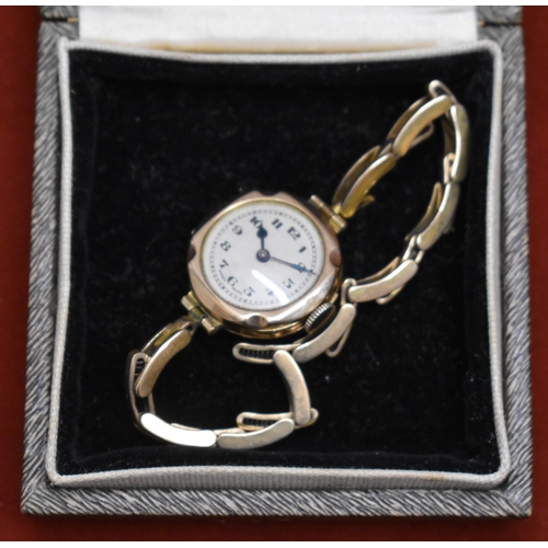 232 - Ladies 9ct Gold Wrist Watch from 1922. Hallmarked case with expandable plated bracelet. Hinged front... 