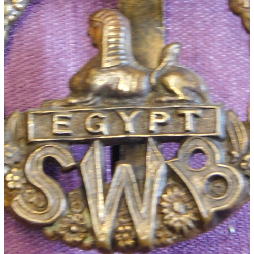 305 - British WWI South Wales Borderers (SWB) Regiment Brass Economy Cap Badge, brass with slider