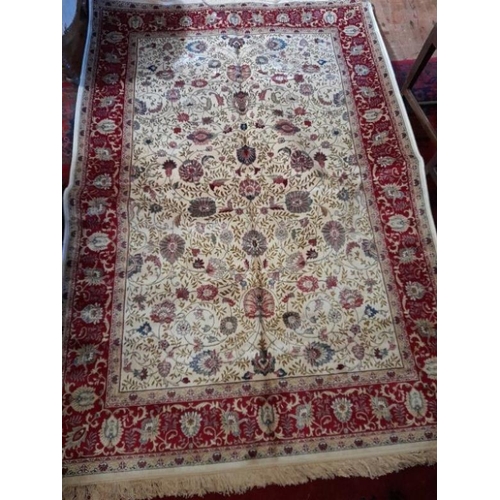 885 - Kashmir Ivory and Red Ground all over Floral pattern Rug produced on a power loom (220cm x 140cm)