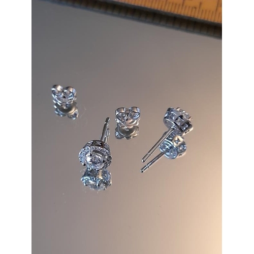 842 - 18 Carat White Gold Diamond Stud Halo Earrings. Diamond weight for the Centre Stone is .95 Carats pl... 