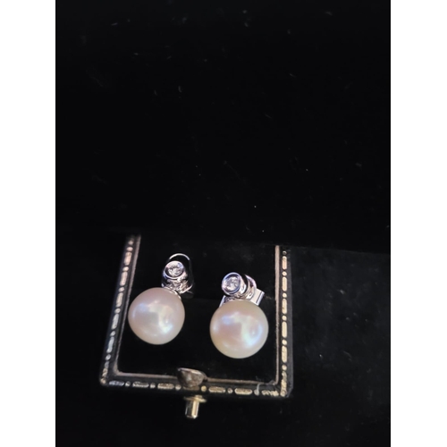 709 - 18 Carat Diamond and Pearl Earrings