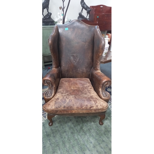 34 - Distressed Tan Leather Wingback Armchair