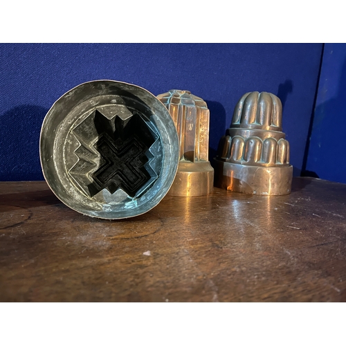 160 - Three Copper Jelly Moulds and a Set of Three Graduated Copper Handled Milk Ladles