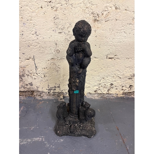 762 - Composite Garden Ornament of a Boy Sitting on a Pedestal Playing a Harmonica