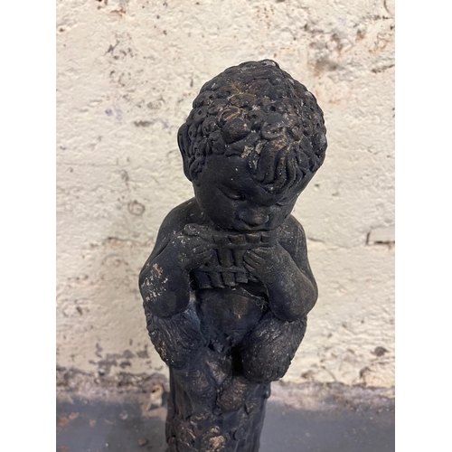 762 - Composite Garden Ornament of a Boy Sitting on a Pedestal Playing a Harmonica