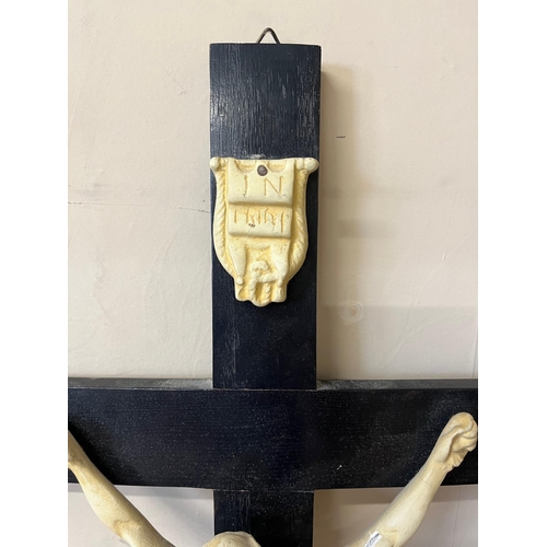 19 - Three Crucifixes on Ebonised Crosses (68 cm H)