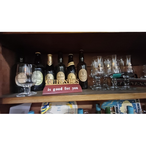 297 - Good Shelf of Guinness Glasses, Bottles and Point of Sale items