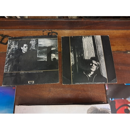 186 - U2 interest - Book and 6 Vinyl Singles in Sleeves