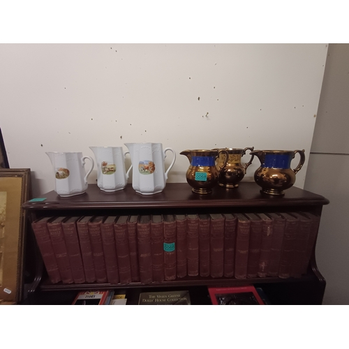 68 - Three Lustreware Milk Jugs and a Set of 3 Graduated Porcelain Dresser Jugs