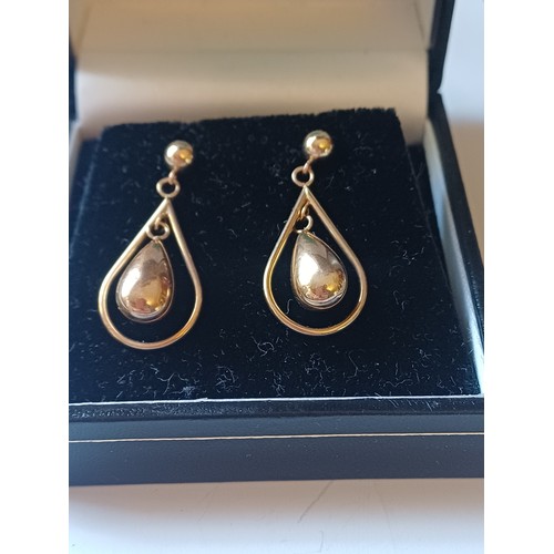234 - Pair of Gold toned pear shaped drop earing with a central stone