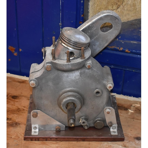 10 - A Rudge single cylinder engine bottom end crank case and piston, mounted on a plinth, with a cylinde... 