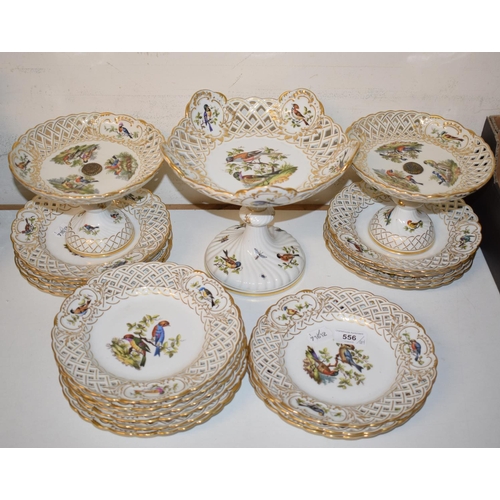 556 - An Augustus Rex porcelain part dessert service, painted birds and with gilt decoration, comprising a... 