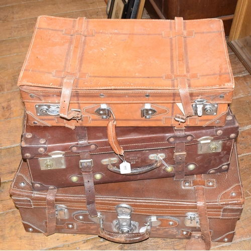 777 - A leather suitcase, with straps, and chrome mounts, 77 cm wide, and two others similar, 66 and 60 cm... 