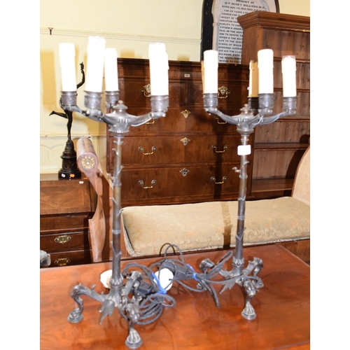 788 - A pair of late 19th century bronze five light candelabra, adapted for electricity, on lioness head l... 