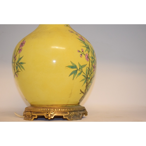 548 - A Chinese vase, decorated prunus on a yellow ground, converted to table lamp, 68 cm high (including ... 