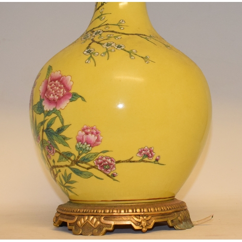 548 - A Chinese vase, decorated prunus on a yellow ground, converted to table lamp, 68 cm high (including ... 