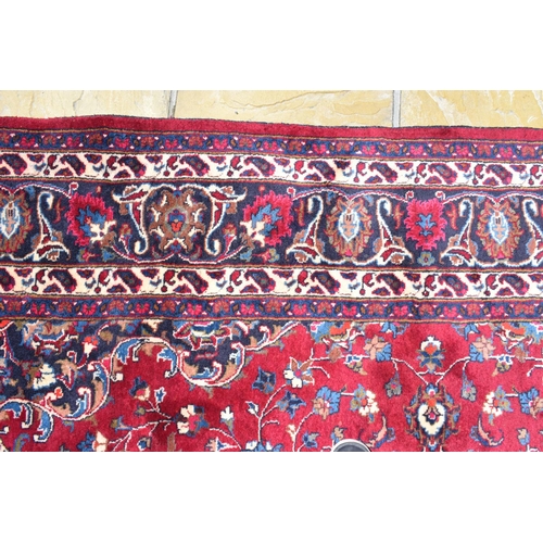 1033 - An Eastern rug, decorated swirling floral motifs on a purple ground, within a multi border, 207 x 30... 