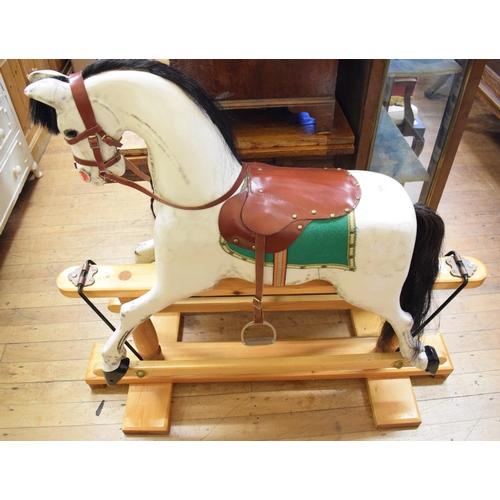 1039 - A carved and painted wood rocking horse, 117 cm wide