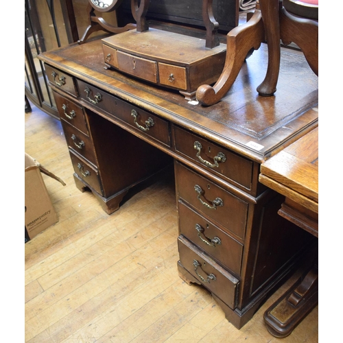 1040 - A pedestal desk, having a leather inset writing surface, 122 cm wide, a dining table, a display cabi... 