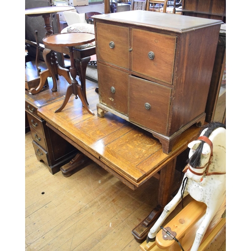 1040 - A pedestal desk, having a leather inset writing surface, 122 cm wide, a dining table, a display cabi... 