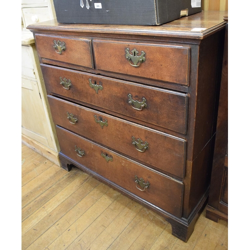 1043 - An oak chest of two short and three long drawers, on bracket feet, 97 cm wide