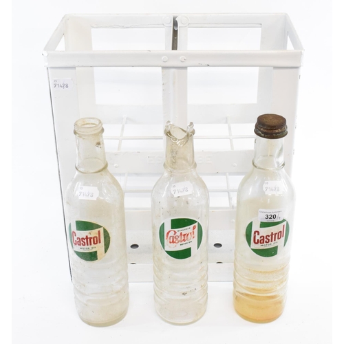 320 - An ESSOLUBE eight division bottle carrier, repainted and three Castrol glass quart oil bottles (4)