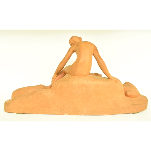 659 - A Continental Art Deco style terracotta group, of a nude lady and two dogs, 27 cm high