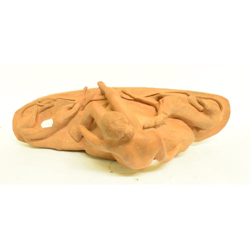 659 - A Continental Art Deco style terracotta group, of a nude lady and two dogs, 27 cm high