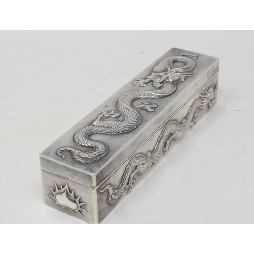 762 - An early 20th century Chinese export silver coloured metal rectangular box, decorated in relief drag... 