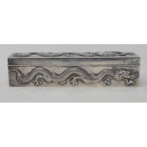 762 - An early 20th century Chinese export silver coloured metal rectangular box, decorated in relief drag... 