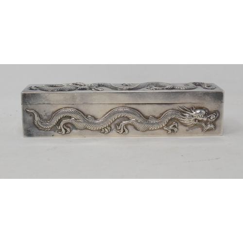 762 - An early 20th century Chinese export silver coloured metal rectangular box, decorated in relief drag... 