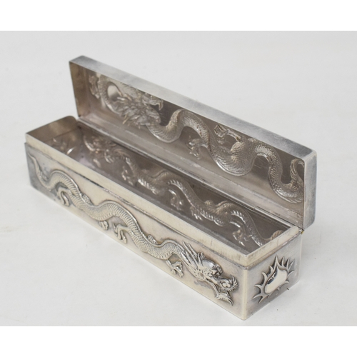 762 - An early 20th century Chinese export silver coloured metal rectangular box, decorated in relief drag... 