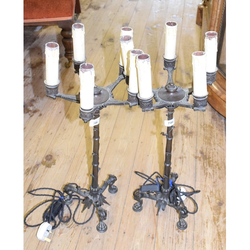 746 - A pair of late 19th century bronze five light candelabra, adapted for electricity, on lioness head l... 