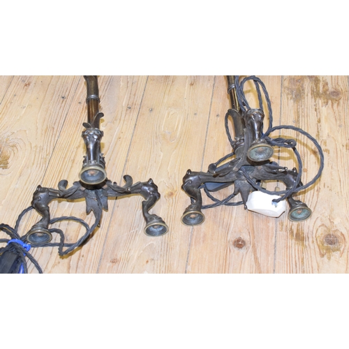 746 - A pair of late 19th century bronze five light candelabra, adapted for electricity, on lioness head l... 