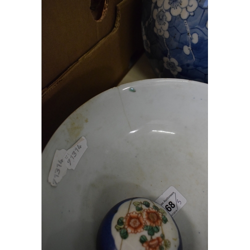 568 - A Chinese porcelain bowl, decorated foliage on a blue ground, cracked, 22 cm diameter, a similar gin... 