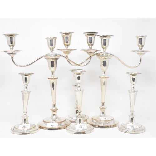 29 - A pair of plated on copper three light candelabra, crested, and a set of four similar table candlest... 