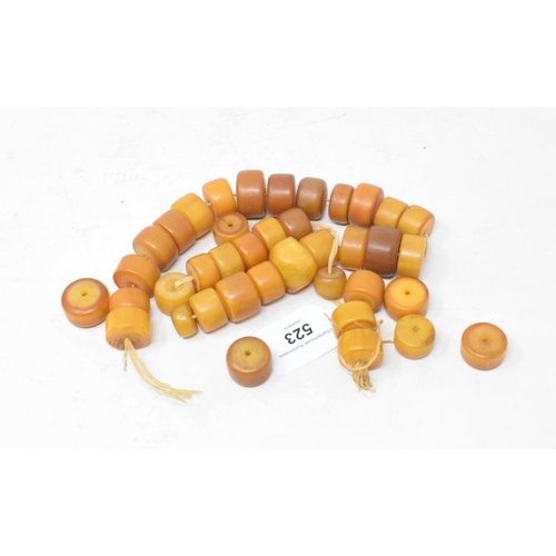 523 - A string of amber type beads, 59 cm