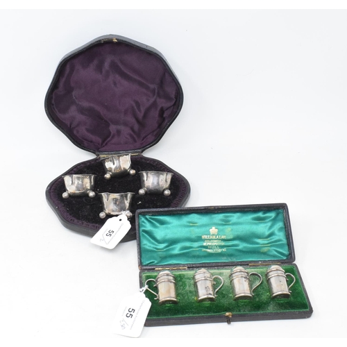 55 - A set of four pepperettes, in the form of casters, Birmingham 1899, boxed, and a set of four silver ... 