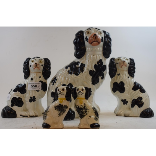 550 - Five Staffordshire pottery spaniels, with black spots, the largest 25 cm high