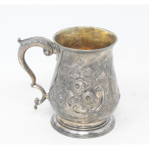 56 - A George III silver mug, initialled, of baluster form, embossed flowers and foliage, London 1766, ap... 