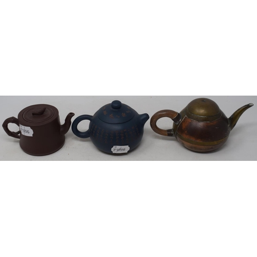 596 - A Yixing pottery teapot, decorated calligraphy, 9 cm high, and two others (3)