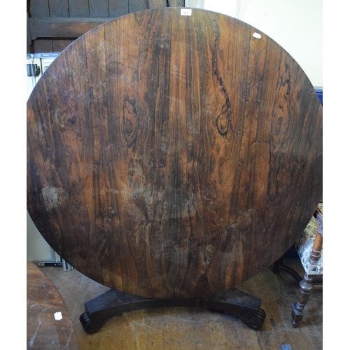 982 - A Regency rosewood tilt top breakfast table, on a triform platform base, 137 cm diameter