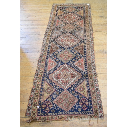 984 - An Eastern runner, decorated geometric motifs on a blue ground, within a multi border, 232 x 86 cm, ... 